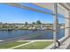 Beautiful water view from the sunroom shows the canal and waterfront homes at 4632 Marine Pkwy # 302, New Port Richey, FL 34652