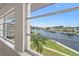 Relaxing water view from the sunroom shows the canal, boats and manicured lawn area at 4632 Marine Pkwy # 302, New Port Richey, FL 34652