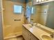 Bathroom with double sinks, shower, and tile flooring at 4713 Tiburon Dr, New Port Richey, FL 34655