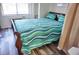 Bedroom with a sleigh bed and teal bedding at 1955 Abrico Dr # G7, Lutz, FL 33558