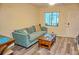 Living area showcasing a teal couch and wood coffee table at 1955 Abrico Dr # G7, Lutz, FL 33558