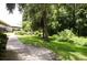 Landscaped grounds with walking path and seating area at 1955 Abrico Dr # G7, Lutz, FL 33558