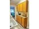 Kitchen features ample wood cabinetry and granite counters at 1955 Abrico Dr # G7, Lutz, FL 33558