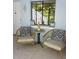 Cozy screened porch with two wicker chairs and small table at 1955 Abrico Dr # G7, Lutz, FL 33558