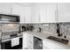 Modern kitchen with stainless steel appliances and white cabinets at 2207 Belleair Rd # A32, Clearwater, FL 33764