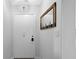 Bright entryway with white door and wood wall mirror at 2207 Belleair Rd # A32, Clearwater, FL 33764