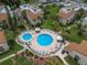 Community pool area with lounge chairs and umbrellas at 2207 Belleair Rd # A32, Clearwater, FL 33764