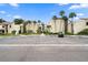 Condo building with parking and tropical landscaping at 2207 Belleair Rd # A32, Clearwater, FL 33764