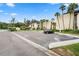 Condo building with parking and tropical landscaping at 2207 Belleair Rd # A32, Clearwater, FL 33764