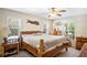 Main bedroom with large wood bed frame and plenty of natural light at 11193 Baltimore St, Weeki Wachee, FL 34614