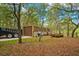 Rustic metal garage with a large door and adjacent trailer at 11193 Baltimore St, Weeki Wachee, FL 34614