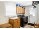Laundry room with washer, dryer, and built-in cabinets at 11193 Baltimore St, Weeki Wachee, FL 34614