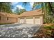 Three-car garage with driveway and landscaping at 11193 Baltimore St, Weeki Wachee, FL 34614