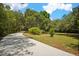 Long private driveway winding through a wooded area at 11193 Baltimore St, Weeki Wachee, FL 34614