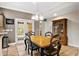 Charming dining room with wooden table and French doors at 11193 Baltimore St, Weeki Wachee, FL 34614