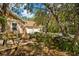 Small patio area with pond, lush plants, and three-car garage at 11193 Baltimore St, Weeki Wachee, FL 34614