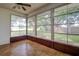 Sunroom with wood tile flooring and garden views at 2727 Featherstone Dr # 2727, Holiday, FL 34691
