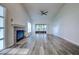 Bright living room with fireplace and wood-look floors at 2727 Featherstone Dr # 2727, Holiday, FL 34691