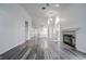 Spacious living area featuring hardwood floors and a fireplace at 2727 Featherstone Dr # 2727, Holiday, FL 34691