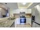 Updated kitchen, featuring stainless steel appliances and granite countertops at 2727 Featherstone Dr # 2727, Holiday, FL 34691