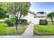 Exterior view showing landscaping and walkway at 2727 Featherstone Dr # 2727, Holiday, FL 34691