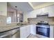 Modern kitchen with stainless steel appliances and granite countertops at 2727 Featherstone Dr # 2727, Holiday, FL 34691