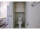 Small bathroom with toilet and storage cabinet at 2727 Featherstone Dr # 2727, Holiday, FL 34691
