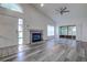 Bright living room featuring hardwood floors, fireplace, and sliding glass doors at 2727 Featherstone Dr # 2727, Holiday, FL 34691