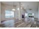 Open living room with vaulted ceilings, fireplace and wood-look floors at 2727 Featherstone Dr # 2727, Holiday, FL 34691
