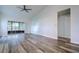 Bright living room featuring vinyl plank flooring and sliding glass doors at 2727 Featherstone Dr # 2727, Holiday, FL 34691