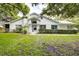 White single-story house with well-manicured lawn and landscaping at 2727 Featherstone Dr # 2727, Holiday, FL 34691
