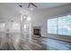 Spacious living room with hardwood floors and a fireplace at 2727 Featherstone Dr # 2727, Holiday, FL 34691
