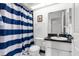 Bathroom with shower/tub combo and nautical-themed decor at 4213 Avanti Cir, New Port Richey, FL 34655