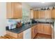 View of a well-equipped kitchen with light wood cabinets and modern appliances at 7413 Gettysburg Dr, Weeki Wachee, FL 34607