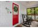 Inviting red front door with a wreath and welcome sign at 7413 Gettysburg Dr, Weeki Wachee, FL 34607