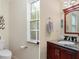 Clean bathroom with toilet, vanity, and large mirror at 7413 Gettysburg Dr, Weeki Wachee, FL 34607