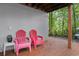 Relax on this deck with two red chairs and a view of the woods at 7413 Gettysburg Dr, Weeki Wachee, FL 34607