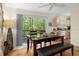 Dining area with wooden table, bench seating, and wooded views at 7413 Gettysburg Dr, Weeki Wachee, FL 34607