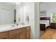 Bathroom with single vanity and view into bedroom at 7413 Gettysburg Dr, Weeki Wachee, FL 34607