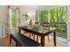 Bright dining area with table, bench, and sliding glass doors leading to a deck at 7413 Gettysburg Dr, Weeki Wachee, FL 34607