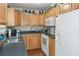 Well-equipped kitchen with light wood cabinets, modern appliances, and tile floor at 7413 Gettysburg Dr, Weeki Wachee, FL 34607