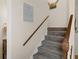 Staircase with wood railing and grey carpeting at 7413 Gettysburg Dr, Weeki Wachee, FL 34607