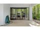 Relaxing screened porch with rocking chairs and a view of the lush forest at 7413 Gettysburg Dr, Weeki Wachee, FL 34607