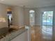 Bright dining room with hardwood floors and access to the pool at 402 Knight Dr, Tarpon Springs, FL 34688