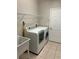Laundry room with washer, dryer, and utility sink at 402 Knight Dr, Tarpon Springs, FL 34688