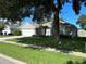 Single-story house with a two-car garage and lush lawn at 402 Knight Dr, Tarpon Springs, FL 34688