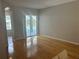 Open living room with hardwood floors and sliding doors to the pool at 402 Knight Dr, Tarpon Springs, FL 34688