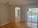 Bright and airy living room with hardwood floors, an archway, and pool view at 402 Knight Dr, Tarpon Springs, FL 34688