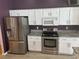 Kitchen boasts stainless steel appliances and white cabinets at 402 Knight Dr, Tarpon Springs, FL 34688