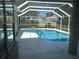 Screened-in pool with a view of the backyard at 402 Knight Dr, Tarpon Springs, FL 34688